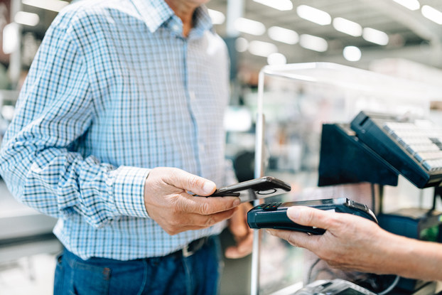 Customer pays for a purchase using contactless payment at POS
