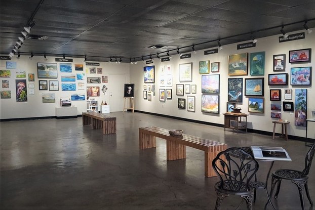 Art gallery with spotlights highlighting art