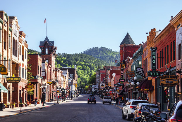 Center view of small town Main Street with shops and restaurants.