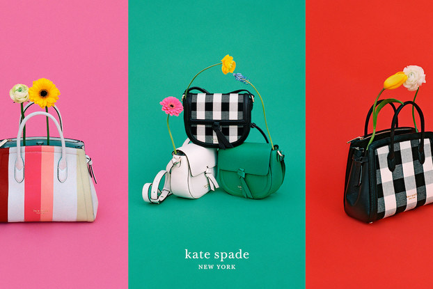 Colorful Kate Spade New York product display with pocketbooks and flowers.