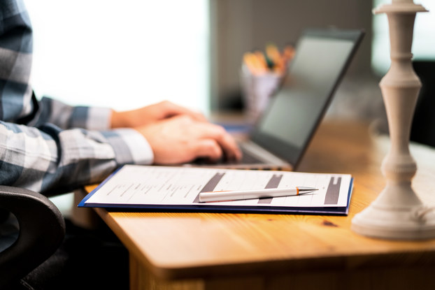 Person working on submitting an application on a laptop.