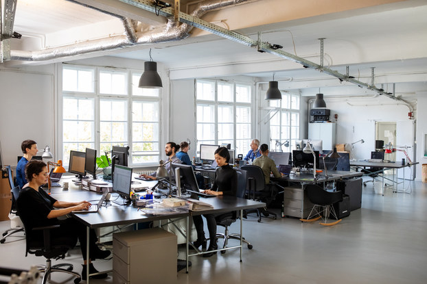 Busy modern open plan office with staff.