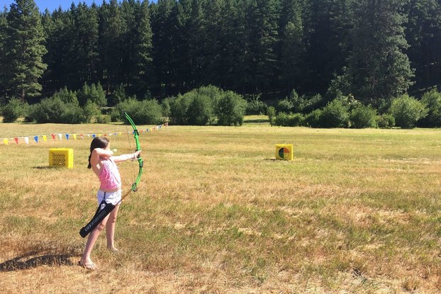 Woman taking archery lessons at Hyatt's Suncadia Resort.