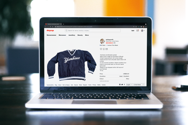 Laptop on table with the screen open to List Perfectly's site, where there is a Yankee's jacket for sale on Depop.