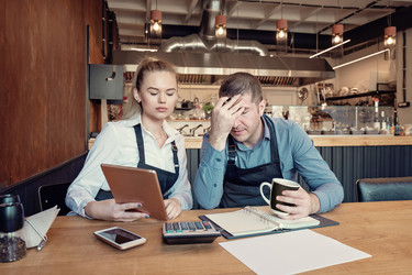  Concerned entrepreneurs calculate financial issue 