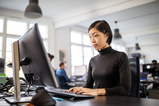 Woman uses computer in a modern office