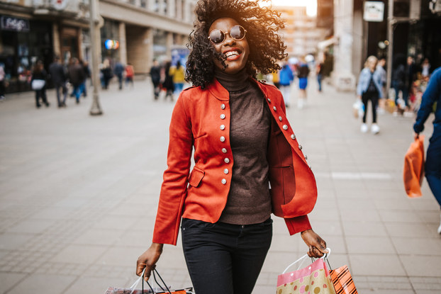 Happy woman holding shopping bags.