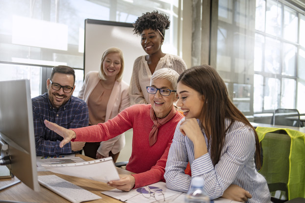 Senior designer demonstrates skills to younger employees