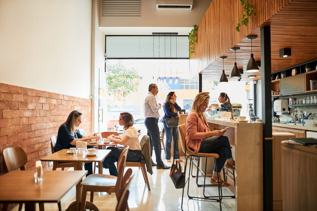 Interior of cafe with patrons sitting around.