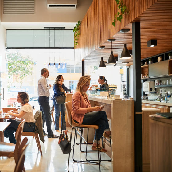 Interior of cafe with patrons sitting around.