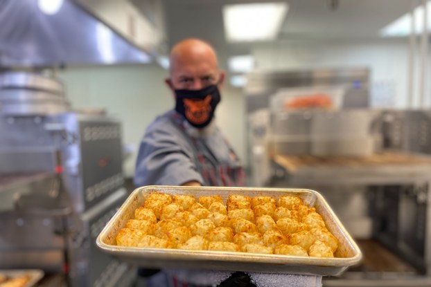 Employee preparing food inside of delivery-only restaurant Cluster Truck.