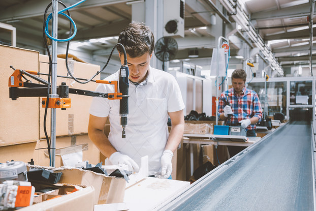 Employees working on production line in a factory.