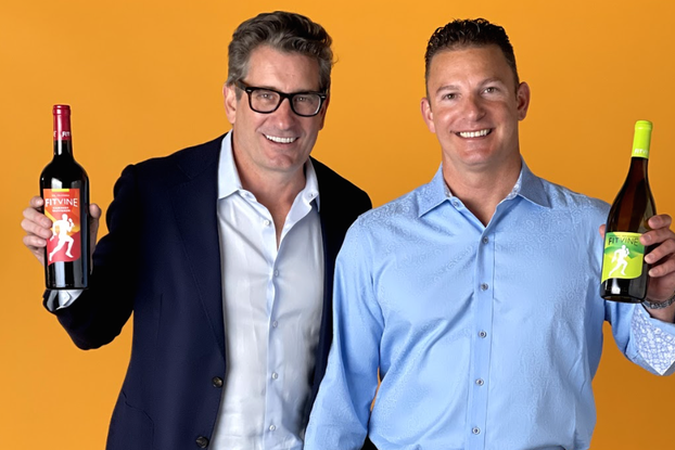 FitVine Wine co-founders, Mark Warren and Tom Beaton holding wine bottles.
