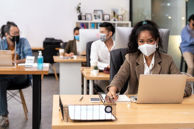Portrait office employees wearing face mask while social distancing