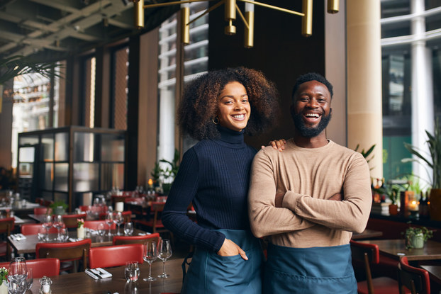 Two minority business owners inside their restaurant.