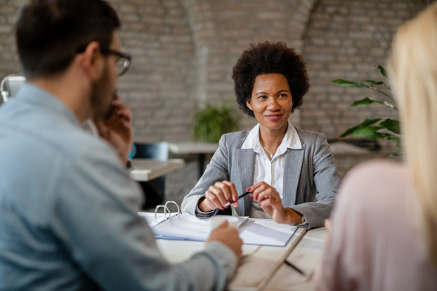 Three professionals in a business meeting.