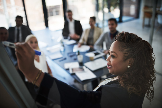 High angle shot of a businesswoman explaining a concept during a presentation to work colleagues in a boardroom.