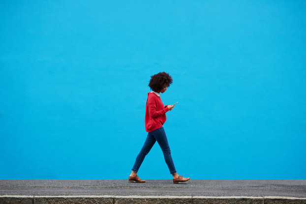 woman walking while on smartphone