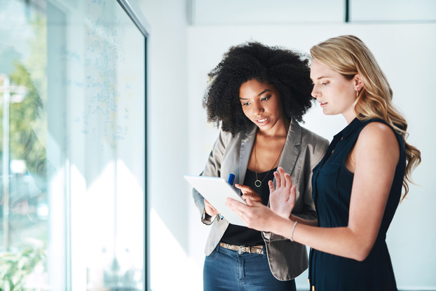 two women looking at paperwork