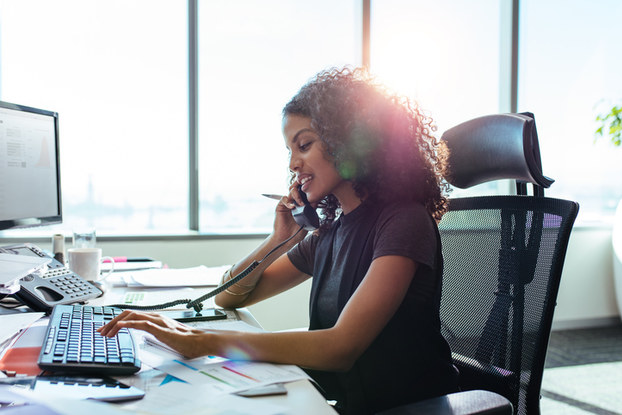 woman on phone at computer