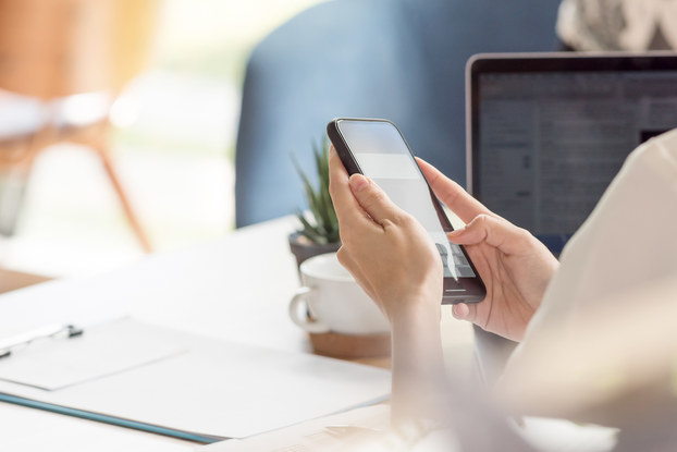 person sitting at desk on phone