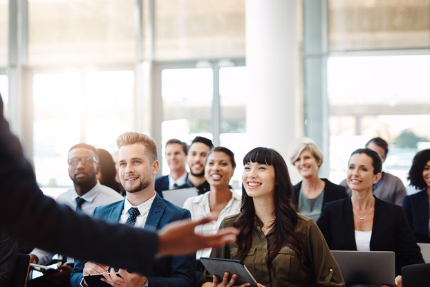 person presenting to a room of professionals