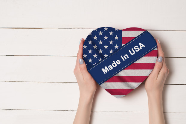 hands holding american flag heart
