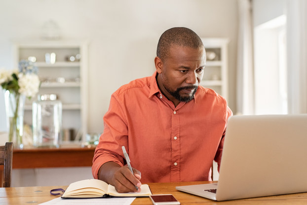 man at home working on laptop