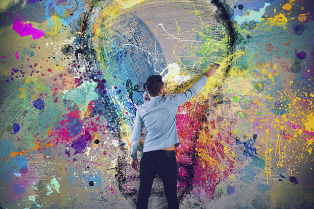 man painting a lightbulb on a wall