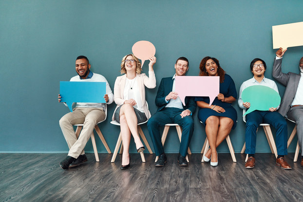 people sitting in a row waiting for job interview
