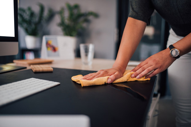 woman cleaning office desk
