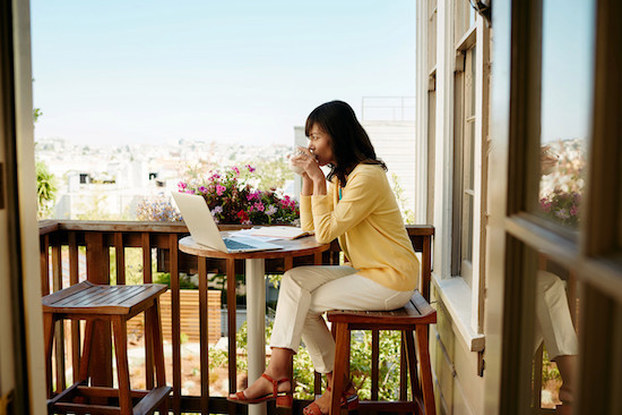 woman sitting outside with laptop