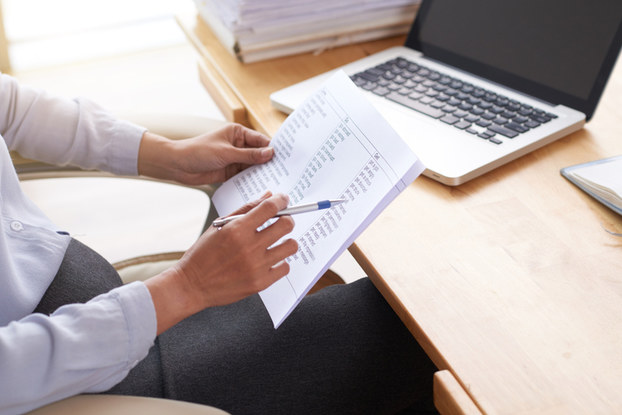 man holding pad and pen