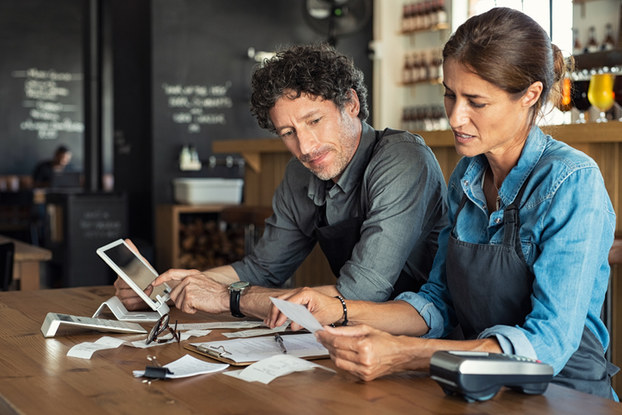man and woman going over business paperwork