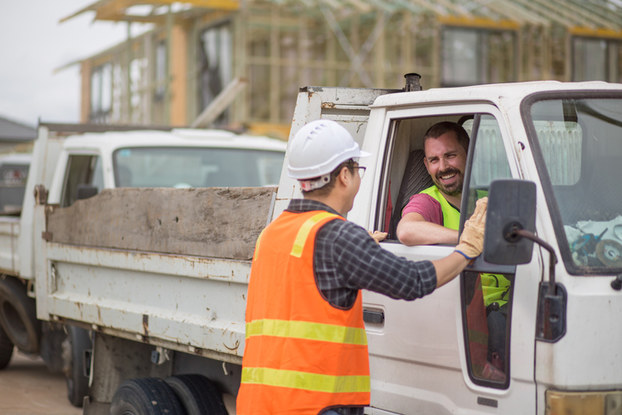 construction workers talking through truck window