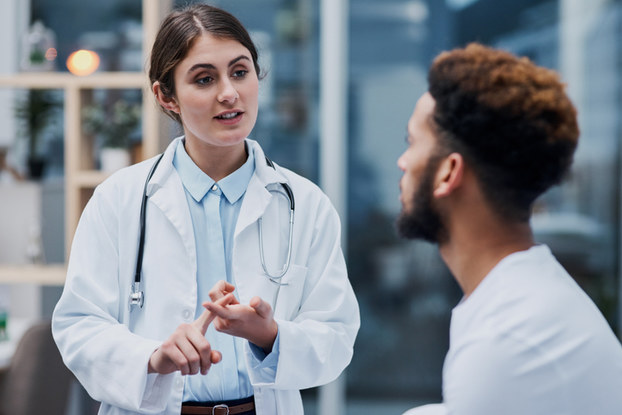 female doctor talking to a male patient