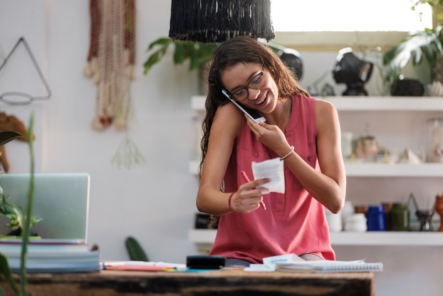 woman on phone looking at papers