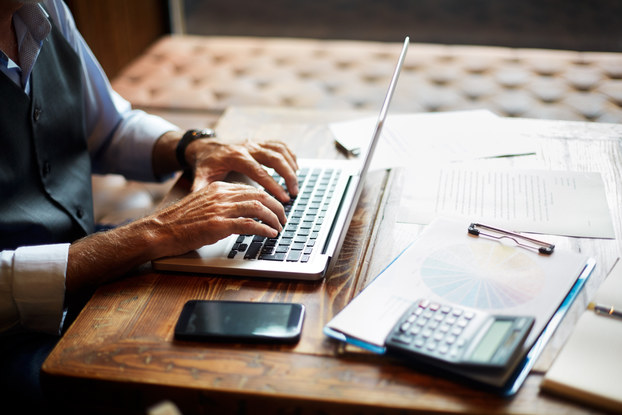 man typing on laptop