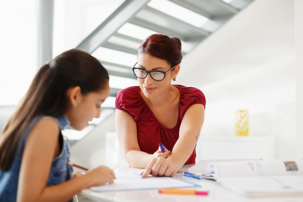 woman tutoring a young girl