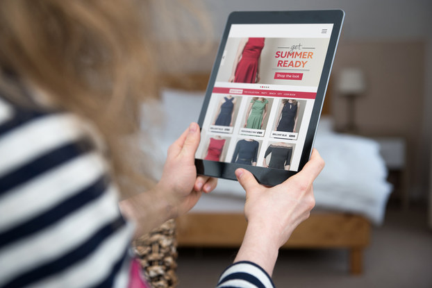 woman browsing a clothing website on a tablet