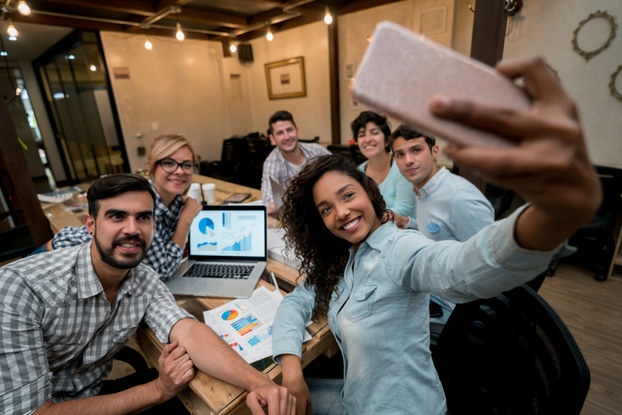 coworkers taking a selfie in the office
