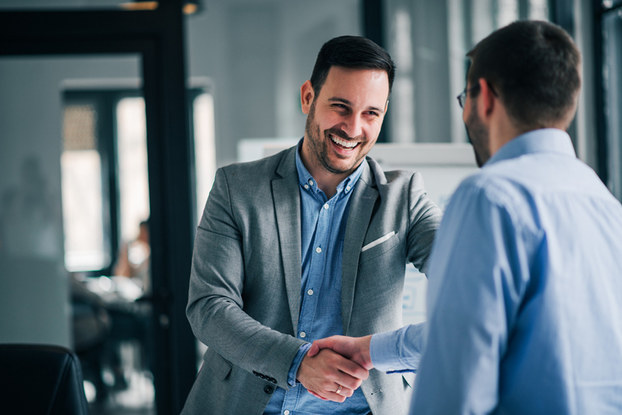 two men shaking hands at work