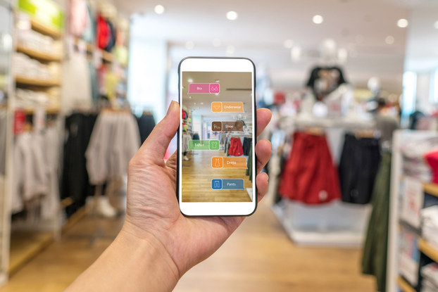 person holding phone showing augmented reality in shopping