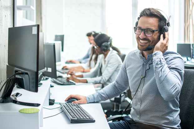man at work on headset and computer