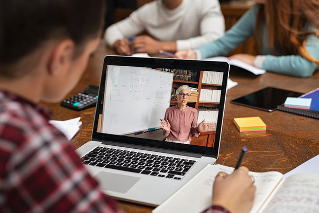 man watching virtual event on laptop