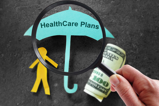 paper cutout of person and umbrella about cost of health care