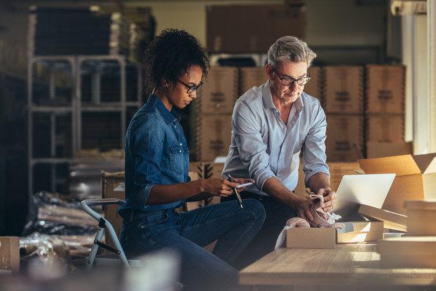 two small business owners packaging an order