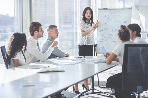 woman giving presentation to board members