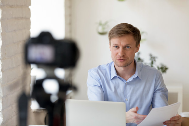man recording video