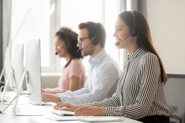 coworkers on laptops with headsets